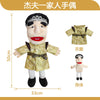 A soft plush hand puppet of a zombie boy wearing a gold-colored outfit and black hair.