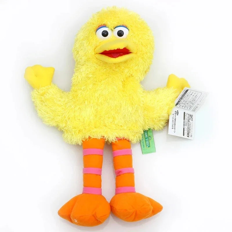 A yellow plush toy of Elmo with large eyes and a red mouth, wearing orange striped feet.