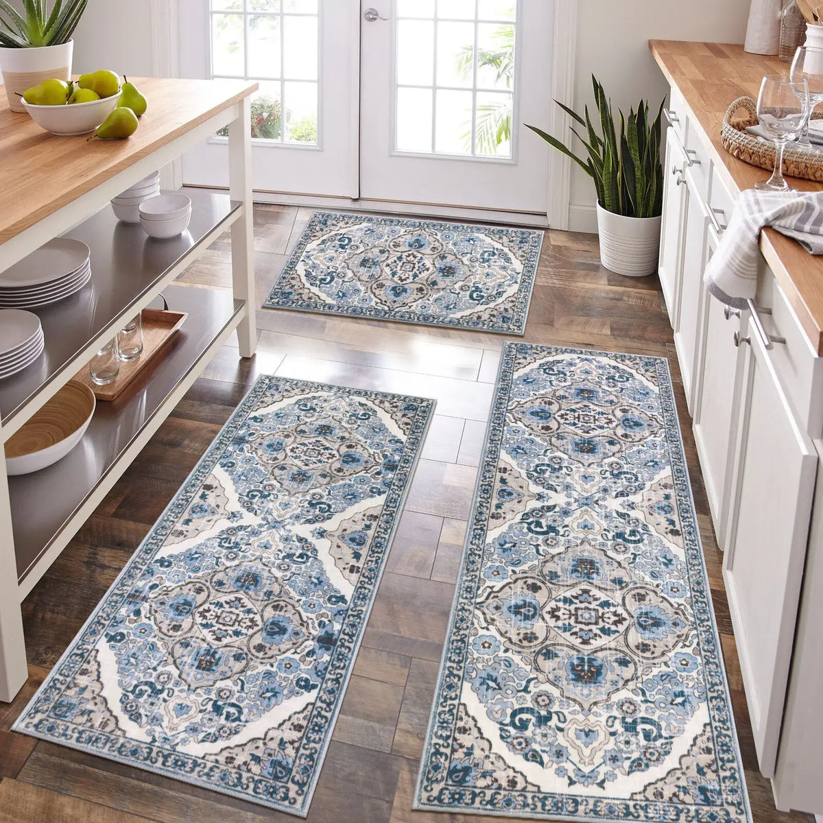 A long rectangular blue and white patterned kitchen rug placed on a wooden floor.