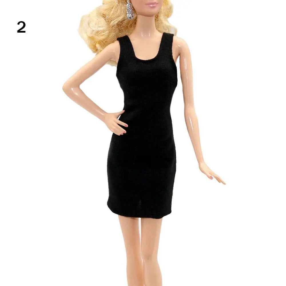 A black mini dress worn by a fashion doll.