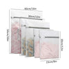 A set of three reusable mesh laundry bags with protective zippers shown in various sizes and colors.