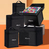 A set of black canvas pencil bags holding various quantities of markers and pens.