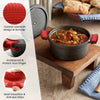 Red silicone pan handle covers with anti-slip grips shown next to a cooking pot and bread.