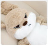A fluffy beige and white long-eared rabbit plush toy looking to the side.