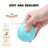 A hand is holding a smooth, light blue, resilient ball pit sphere, demonstrating its soft and resilient properties.
