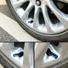 Close-up view of an aluminum alloy wheel showing four blue valve caps installed in the wheel hub.