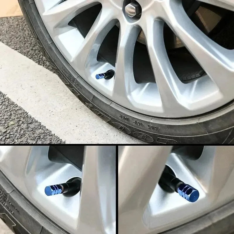Close-up view of an aluminum alloy wheel showing four blue valve caps installed in the wheel hub.