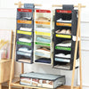 A wooden hanging organizer with labeled daily pockets for weekly closet organization.