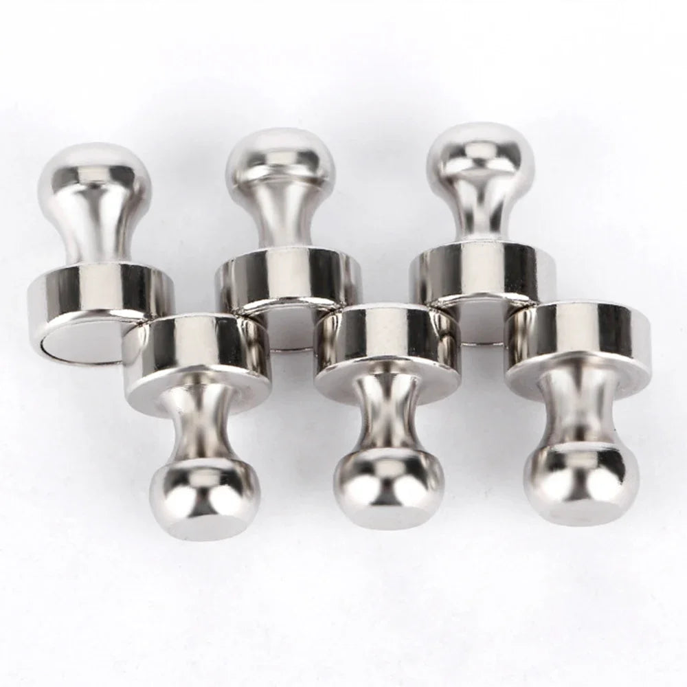 A set of silver neodymium magnetic pushpins used for fastening items on whiteboards and surfaces.