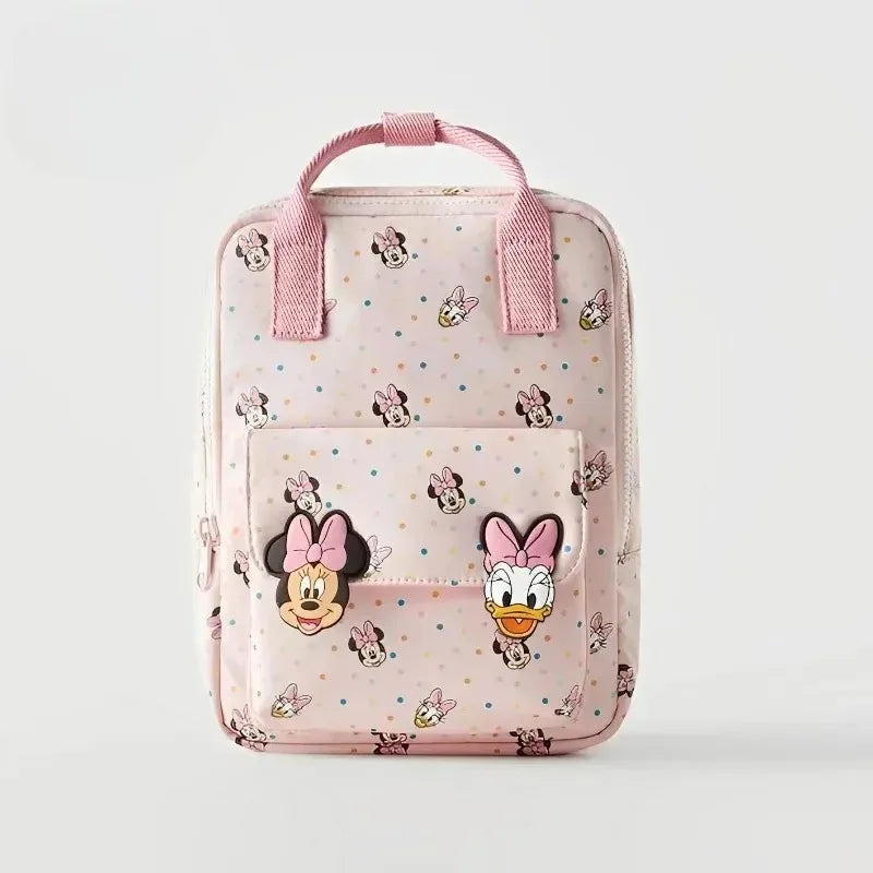 A pink backpack featuring a cute cow print pattern and Minnie Mouse designs.