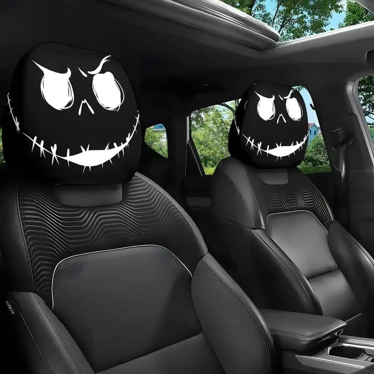 A pair of black car headrest covers featuring creepy, smiling skull faces for a horror theme.