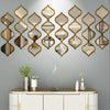 A decorative wall featuring a series of gold-framed, ornate mirrors mounted on a gray wall above a white cabinet.