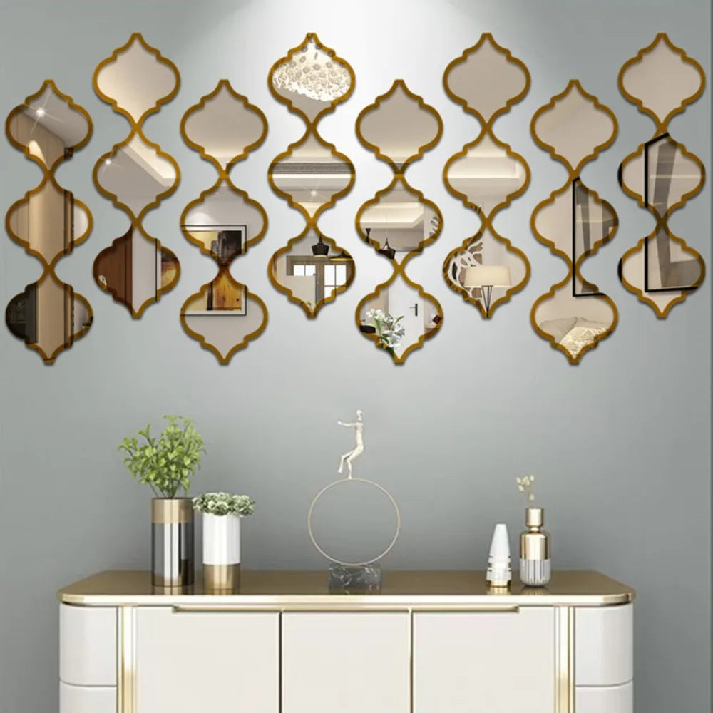 A decorative wall featuring a series of gold-framed, ornate mirrors mounted on a gray wall above a white cabinet.