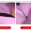 Close-up view of a black two-way zipper and reinforced material on a pink fabric bag.