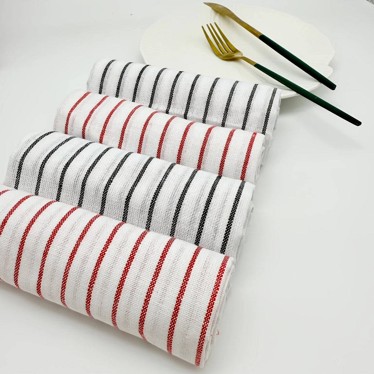 A stack of striped lint-free kitchen dishcloths in white and red are displayed next to a gold fork and knife.