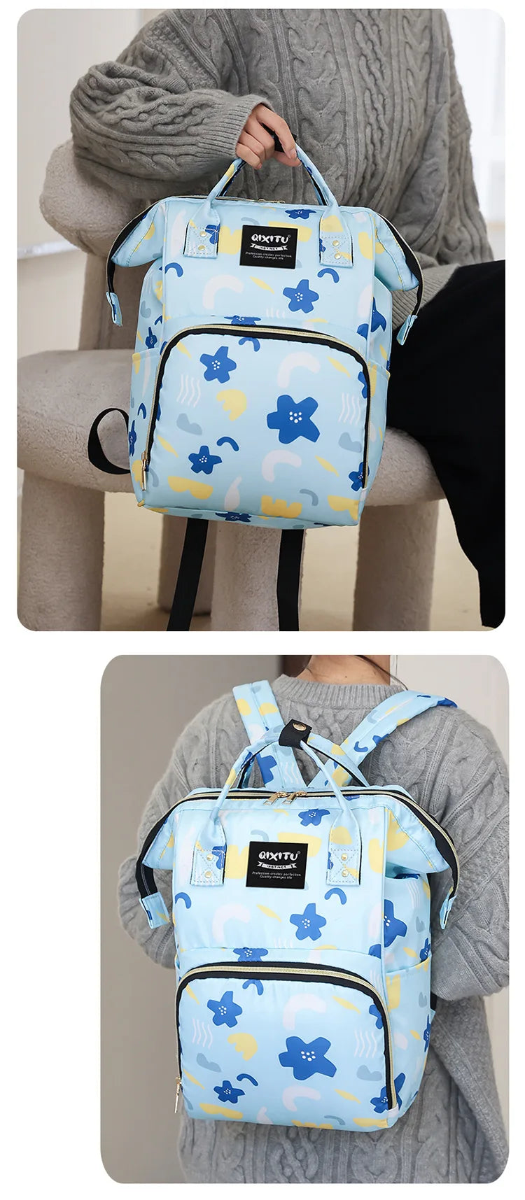 A light blue waterproof backpack diaper bag with blue floral patterns and black straps being held by a person.