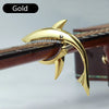 Gold shark-design guitar capo with zinc alloy build shown on a wooden guitar neck.