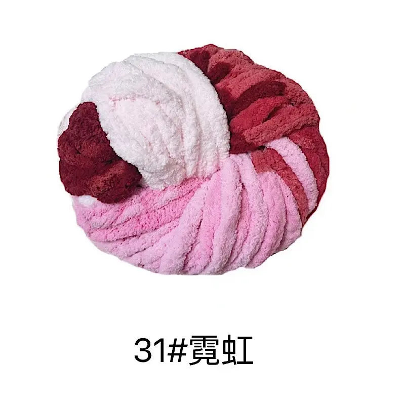 A ball of chunky acrylic yarn featuring a marbled pattern of pink and deep red colors.