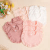 A set of three soft cotton ruffle bibs in pink and white for babies