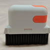 A white and orange multi-purpose crevice cleaning brush with black bristles.