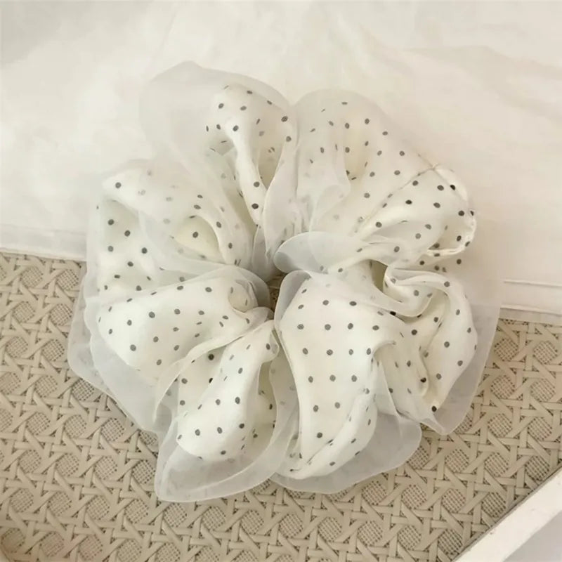 White polka dot mesh scrunchie hair ties shown on a light surface.