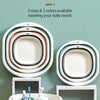 A set of three nested plastic wash basins in various shades of white and pink resting on a light wooden surface.