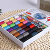 A white storage case holds numerous colorful sewing threads arranged in rows, with a pair of scissors visible.