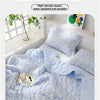 A light blue quilted blanket with a floral pattern is shown folded on a bed, emphasizing silky and naked sleeping.