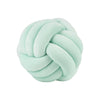A soft, light mint green knitted or knotted velvet throw pillow with a round shape.