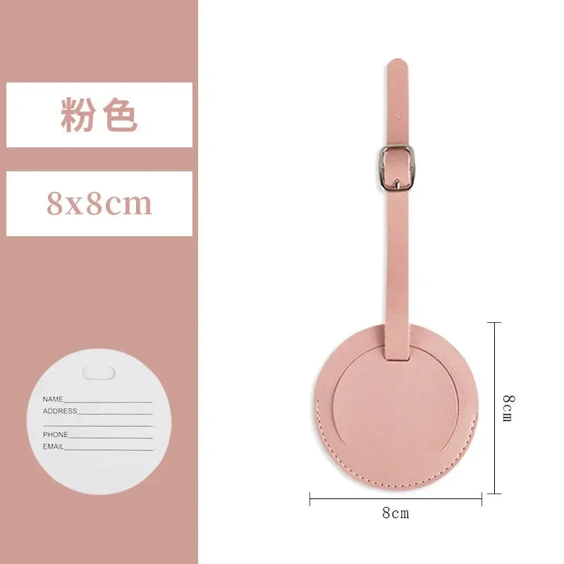 A pink PU leather luggage tag with a round cutout and a rectangular attachment loop.