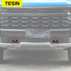 Front bumper tow hook cover for Chevrolet Silverado and GMC Sierra vehicle.