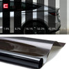 A roll of dark automotive window tint film being rolled out for application.