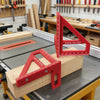 A red multi-angle measuring ruler is placed on a wooden block for woodworking and DIY projects.