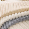 A close-up of a cozy plush anti-slip sofa cushion mat featuring horizontal stripes in cream, beige, and gray faux fur.