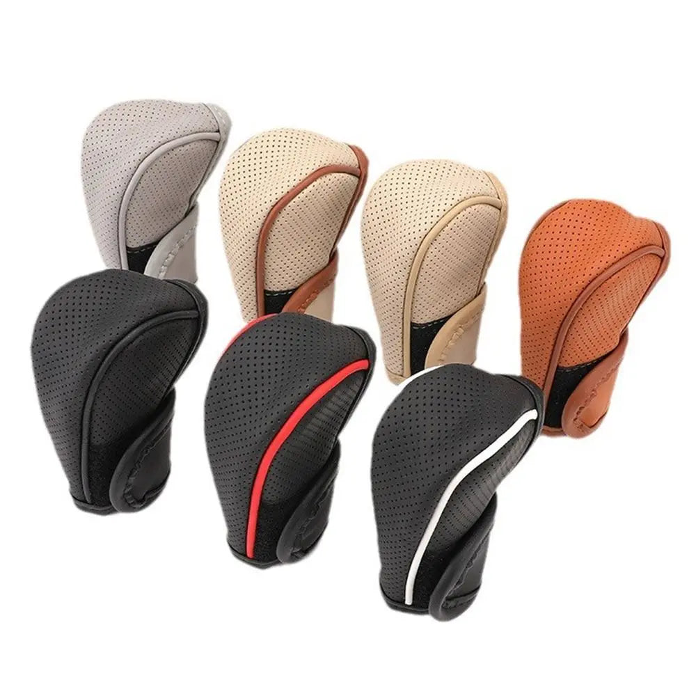 A collection of leather gear shift knob covers in various colors including gray, beige, black, and orange.