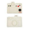 A beige silicone baby teether toy shaped like a remote control with various buttons and features.