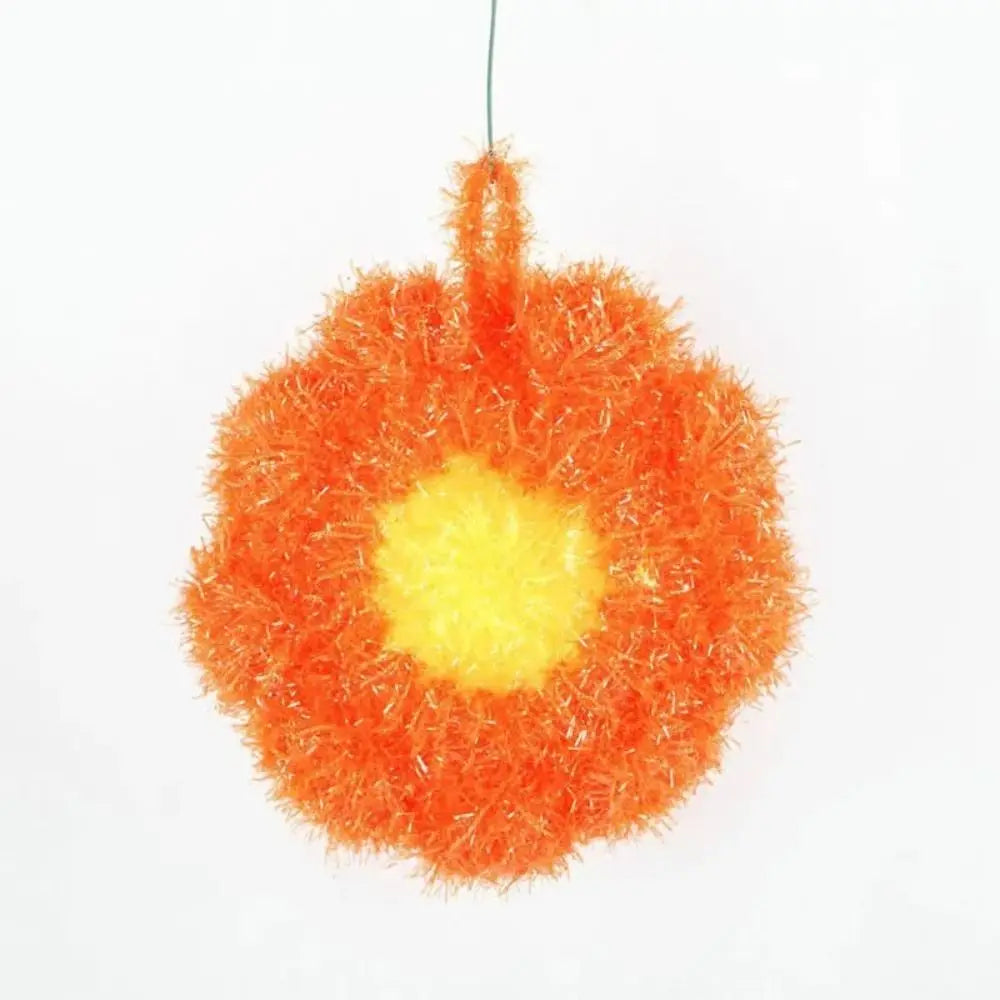 A bright orange, fluffy acrylic non-stick dish sponge with a yellow center.