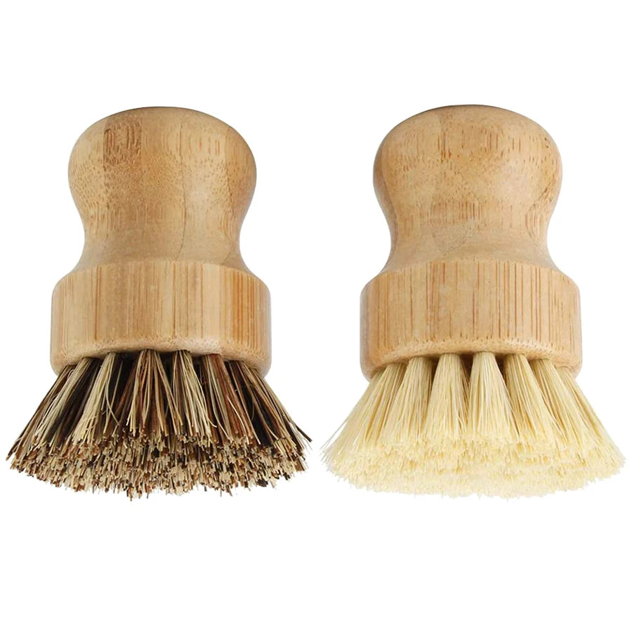 A pair of natural bamboo dish scrub brushes with light-colored sisal bristles.