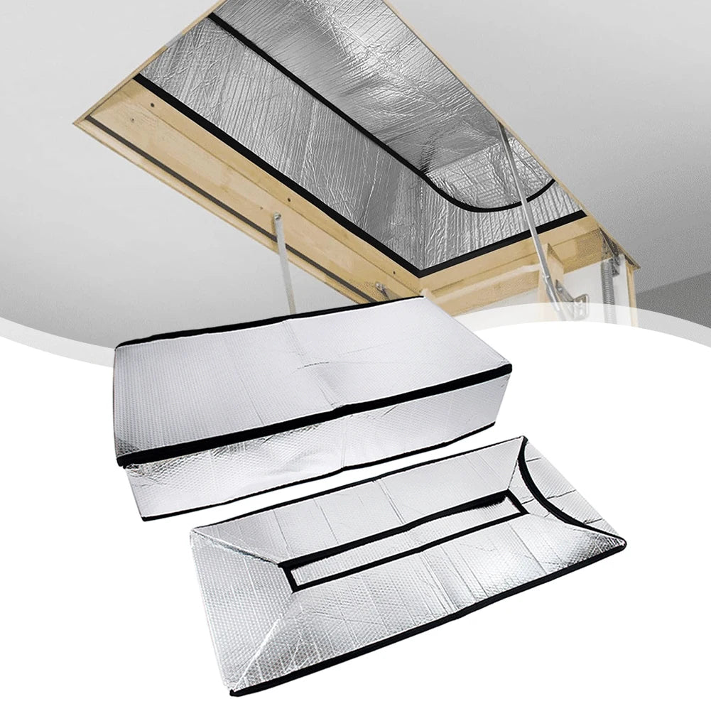 Silver insulation cover for an attic stairway, showing a sealed barrier and wooden framing.