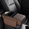 A brown car armrest cushion with a textured cover and integrated cupholders and storage compartments.