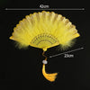 A yellow lace folding hand fan with a decorative fan and a long golden handle.