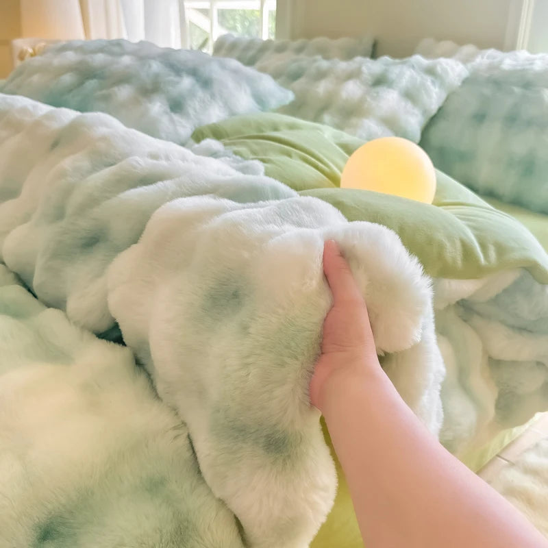 A hand touches a fluffy, light green and blue patterned fleece duvet cover with a yellow light bulb resting on the fabric.