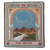A rectangular woven throw blanket featuring a celestial design with a moon, mountains, and lions.