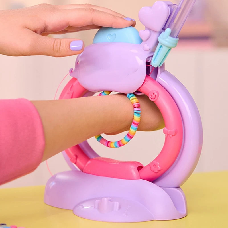 A hand is using a purple and pink DIY friendship bracelet making kit to create a bracelet on an arm.