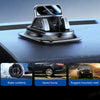 A black 360° rotating car dashboard phone mount with an anti-slip silicone base shown on a dark surface.
