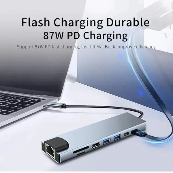 A silver 8-in-1 USB-C hub with multiple ports is shown next to a laptop, demonstrating fast charging capabilities.