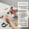 A hand is using a pink cordless hot glue gun with a square-circle nozzle to apply glue, demonstrating its features.
