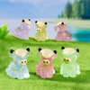 A set of four adorable resin highland cow figurines in various shades of pink and yellow sitting on green grass.