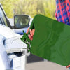 A hand is holding a green leak-proof seal for a universal Jerry can spout on a vehicle.