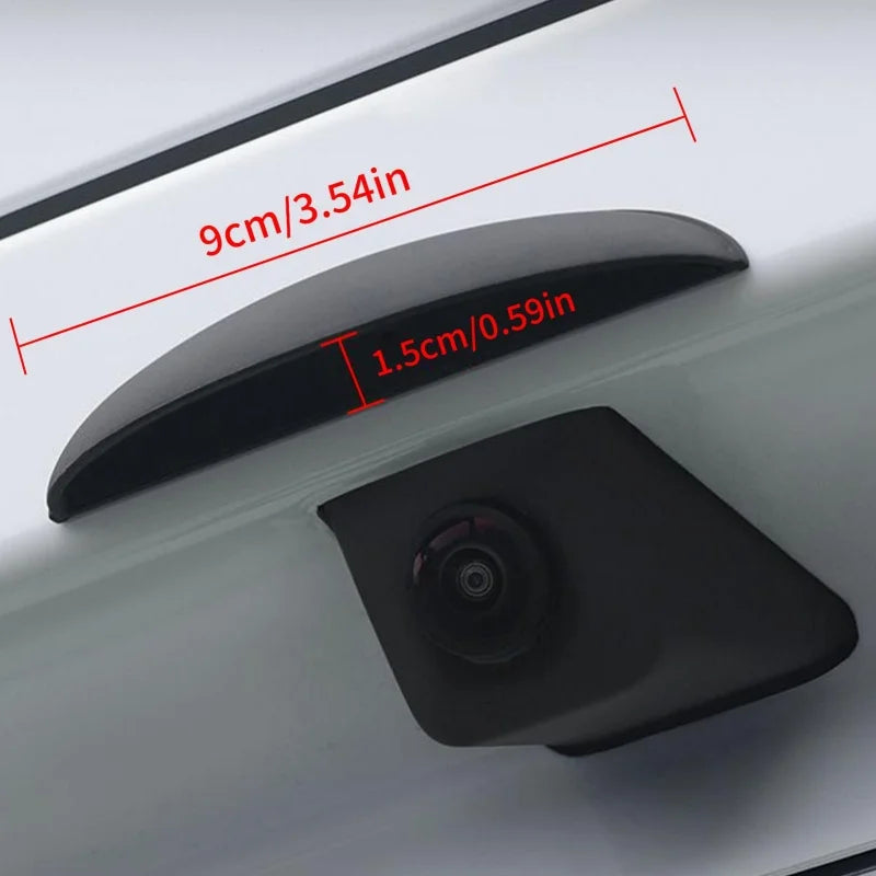 A black universal car rear camera rain cover shield is shown mounted on a white surface with dimension markings.